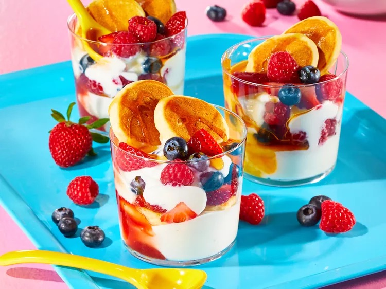 mini pancakes layered with fresh fruits and yoghurt in a glass