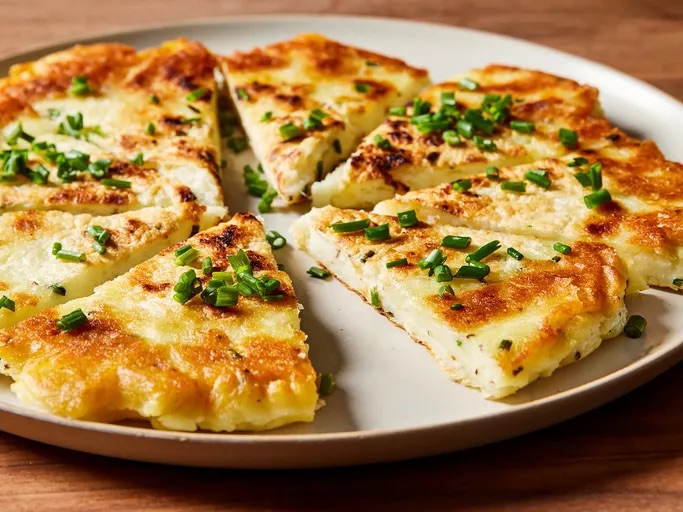crispy mashed potato pancake sliced like pizza
